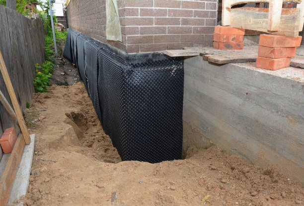 Happy homeowners after waterproofing job in East Leroy